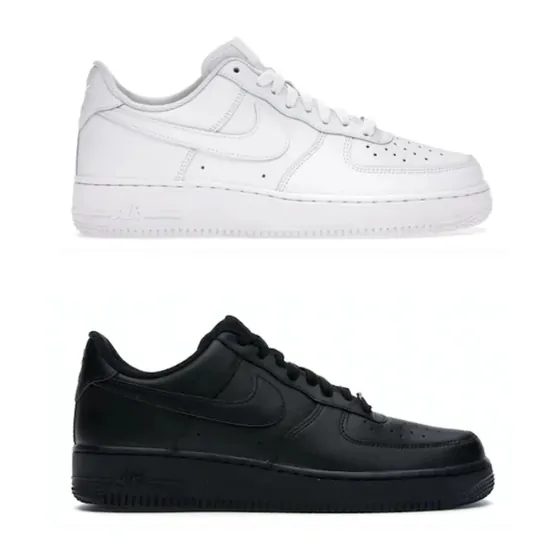 One all-white and one all-black leather low-top trainer on white