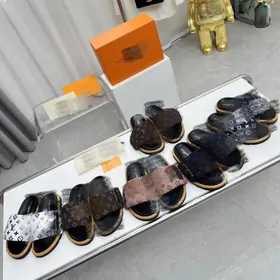 A line-up of patterned and fur-topped slides on a white shelf