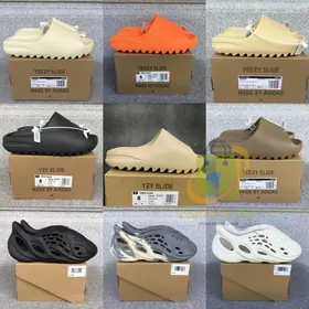 Foam slides and cut-out clogs in cream, orange, black and brown on boxes
