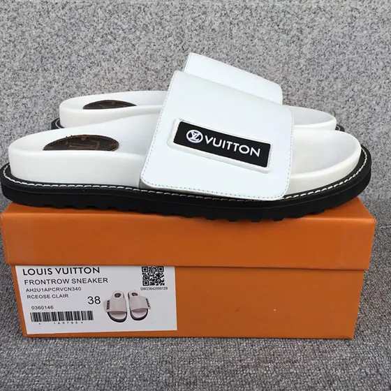 White padded-strap platform sandals on an orange box