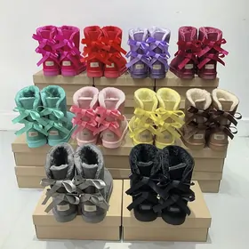 Stacks of fluffy boots with bows in pink, purple, mint, yellow, grey and black