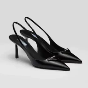 Black leather slingback pumps on a grey background