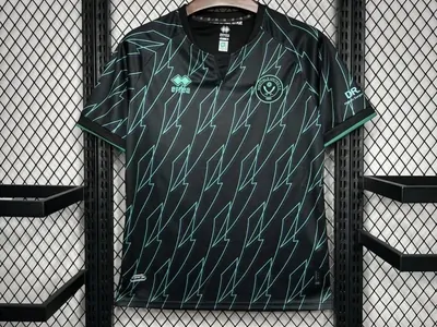 A dark green patterned sports shirt on a hanger