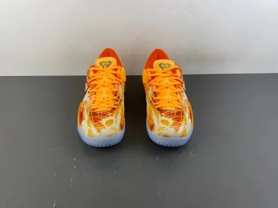 A pair of orange trainers on a grey floor